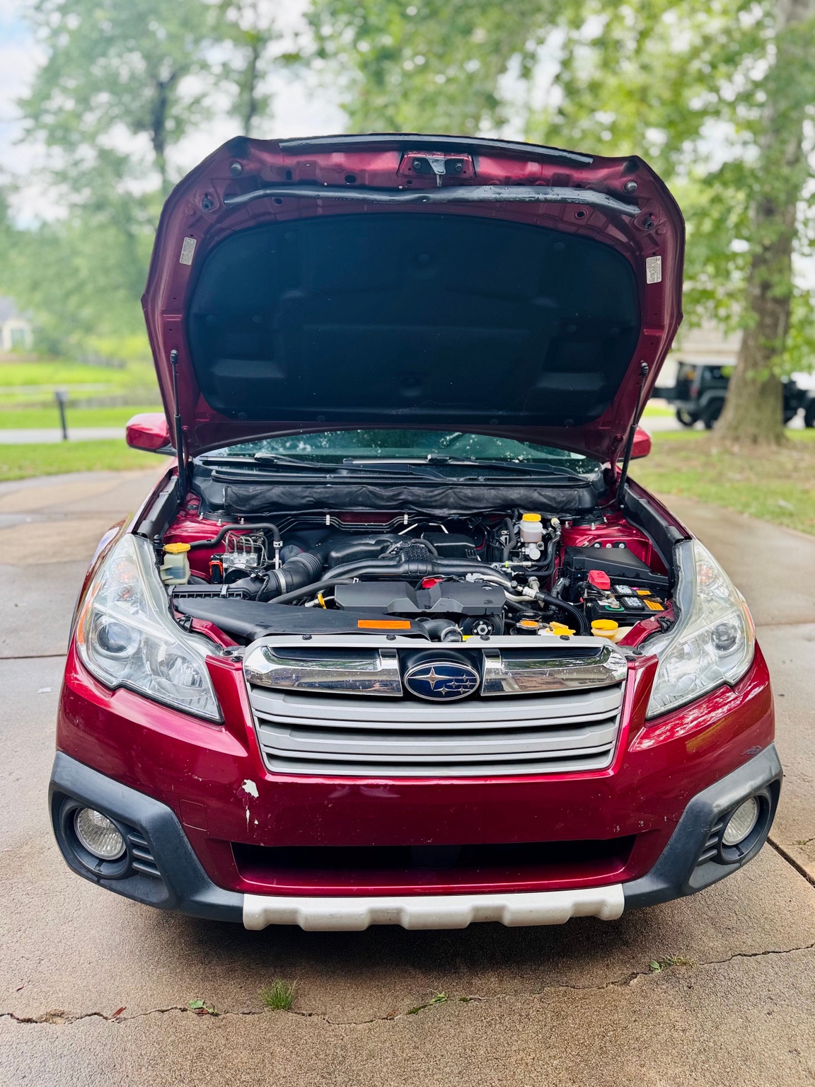 Red Subaru engine bay after care