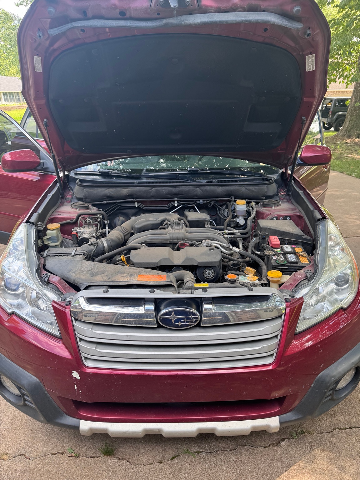 The same red Subaru engine bay before care