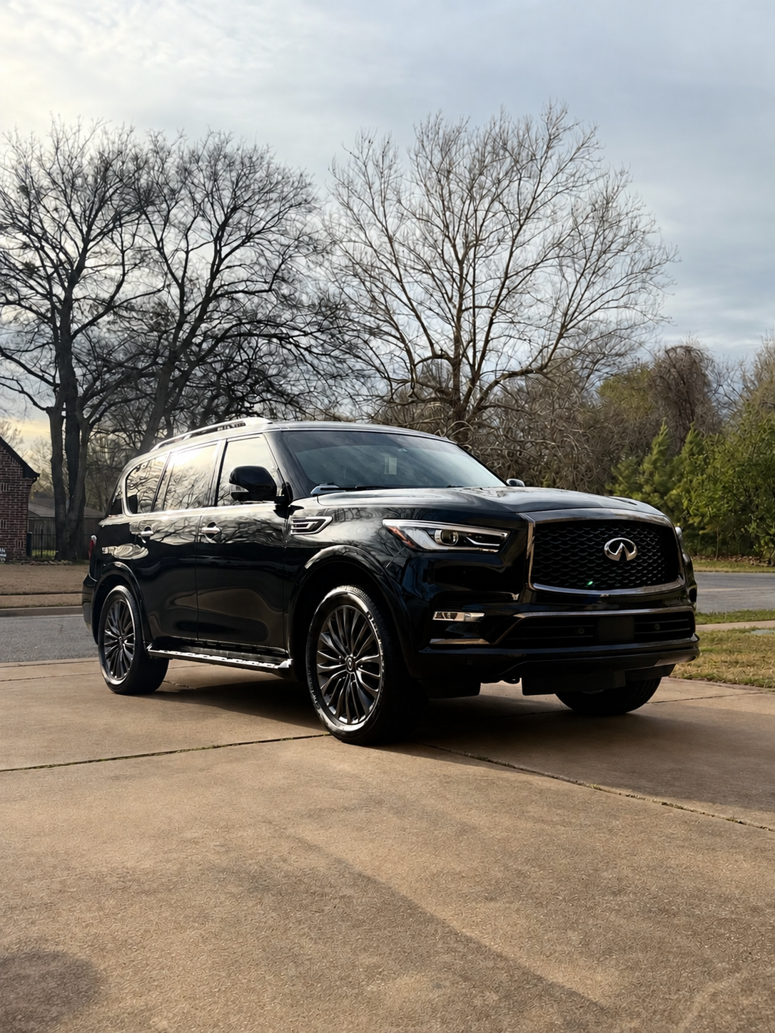 Glossy black Infiniti SUV parked on a driveway