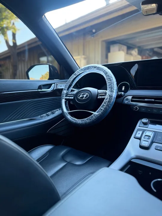 Clean dark Hyundai cabin with protected steering wheel