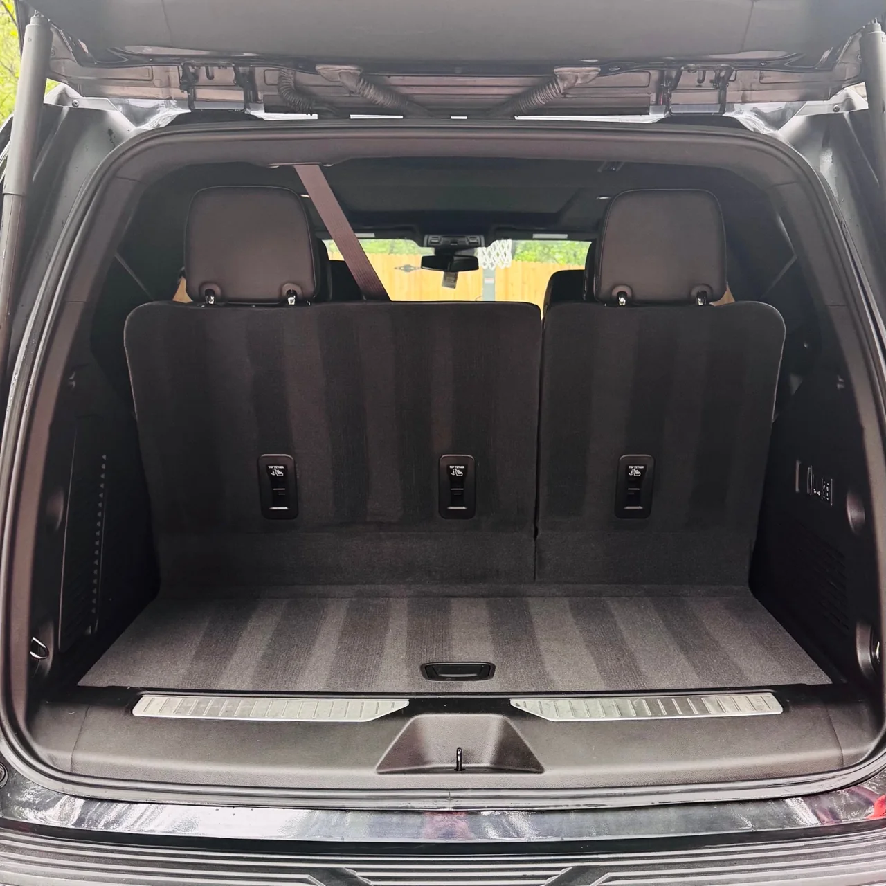 Clean charcoal cargo-area carpet with neat grooming lines