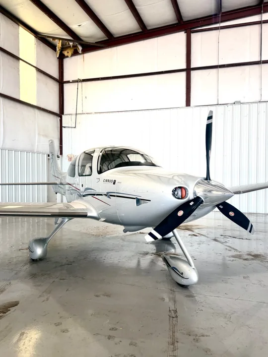 White Cirrus aircraft photographed in a hangar