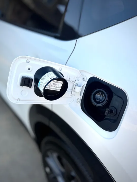 Clean open fuel-filler compartment on a white vehicle