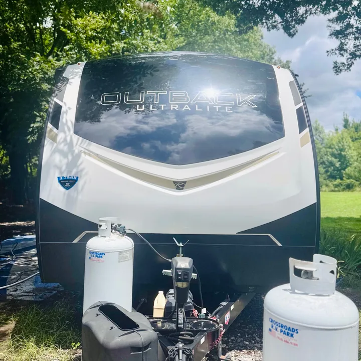 White travel trailer viewed head-on outdoors